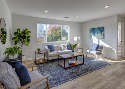 Living room with abundant natural light and grey couches