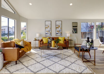 Stylish living room with orange leather couches and yellow accents